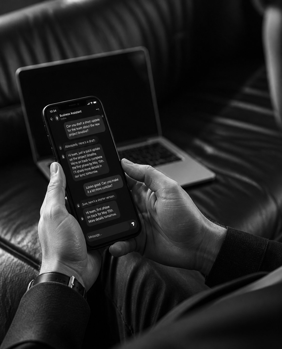 Hands holding a phone showing a chat with a business AI assistant